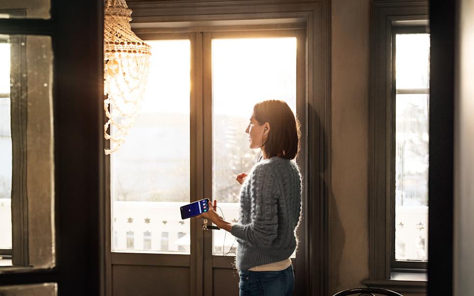 Woman on a phone call using headphones.